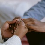 couple holding hands with a therapist, symbolizing marriage healing