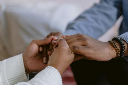 couple holding hands with a therapist, symbolizing marriage healing