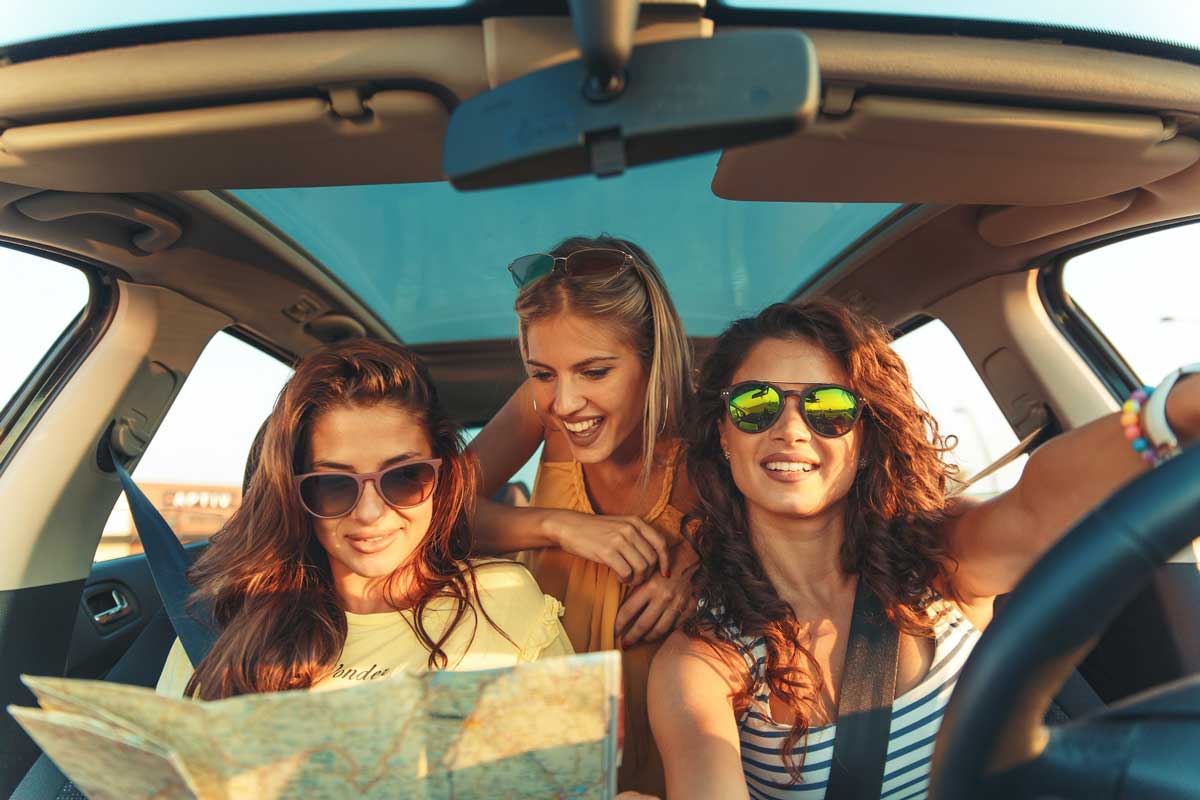 A professional travel planner organizing weekend getaway materials, representing comprehensive travel planning and destination research