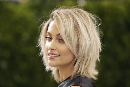 Professional hair colorist working on a client's hair with modern coloring techniques, representing hair color trends
