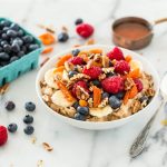 healthy breakfast with fruits, nuts, and a smoothie for moms