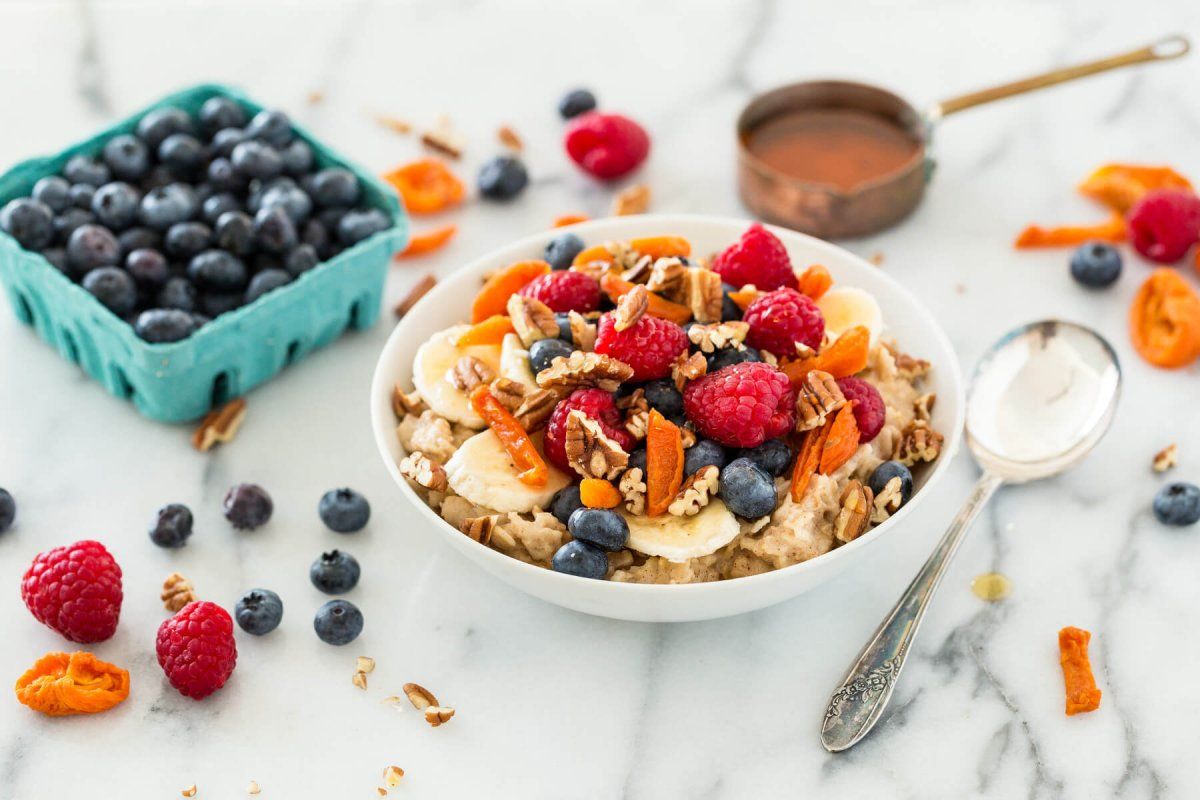 healthy breakfast with fruits, nuts, and a smoothie for moms