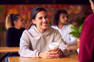 couple calmly talking and smiling, practicing healthy communication