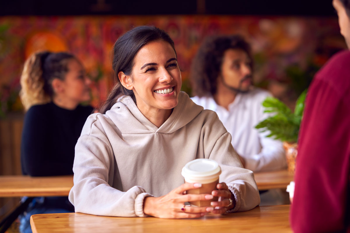 couple calmly talking and smiling, practicing healthy communication
