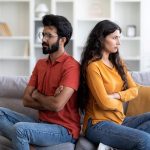 couple sitting across from each other calmly discussing, resolving conflict