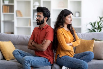 couple sitting across from each other calmly discussing, resolving conflict