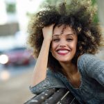 woman with a stylish, youthful haircut smiling at the camera