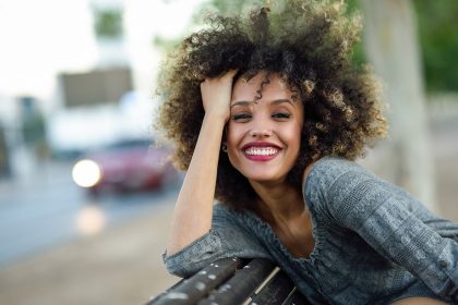 woman with a stylish, youthful haircut smiling at the camera