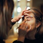 Professional makeup artist demonstrating eye makeup application on different eye shapes, representing personalized eye makeup techniques