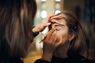 Professional makeup artist demonstrating eye makeup application on different eye shapes, representing personalized eye makeup techniques